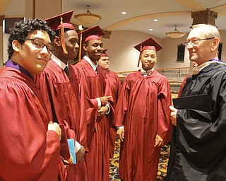 William D. Lewis The Vindicator Lawrence Bozick a retired Mooney English teach who was also the commencement speaker talks with a group of grads before 5-28-17 commencement at Stambaugh Auditorium.