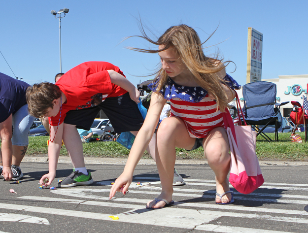 Gianna Pinciaro (12,right) and Nicholas Morar (13) of Boardman pick up candy during the Memorial Day Parade in Boardman on Monday morning.   Dustin Livesay  |  The Vindicator  5/29/17  Boardman.