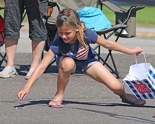 Haley Bero (7) of Boardman picks up candy during the Memorial Day Parade in Boardman on Monday morning.   Dustin Livesay  |  The Vindicator  5/29/17  Boardman.
