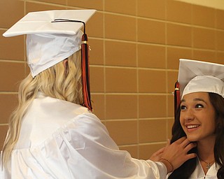 Leah Pollifrone(right) gets help with her hair from Sara Price during the Howland High School Graduation at Packard Music Hall, Wednesday, May 31, 2017 in Warren...(Nikos Frazier | The Vindicator)
