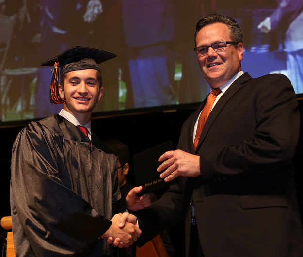 George Beatty-Marsh shakes board president Ken Jones's hand after receiving his diploma during the Howland High School Graduation at Packard Music Hall, Wednesday, May 31, 2017 in Warren...(Nikos Frazier | The Vindicator)