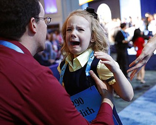 Justin Fuller picks up his daughter Edith Fuller, 6, from Tulsa, Okla., as she cries after she didn't make the group of finalists of the 90th Scripps National Spelling Bee, Wednesday, May 31, 2017, in Oxon Hill, Md. (AP Photo/Alex Brandon)