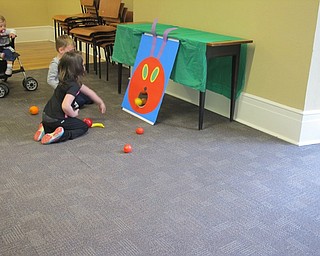Neighbors | Alexis Bartolomucci.Children threw plastic fruit into the caterpillar's mouth for the "Very Hungry Caterpillar" program at the Poland library.