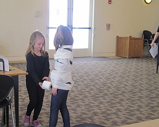 Neighbors | Alexis Bartolomucci.Guests at the Austintown library for the Diary of a Wimpy Kid event wrapped each other in toilet paper for one of the stations.