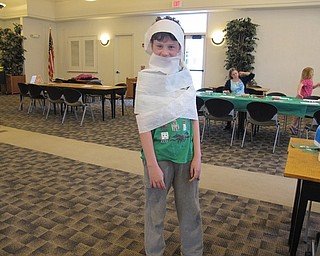 Neighbors | Alexis Bartolomucci.One of the children at the Austintown library got wrapped in toilet paper for one of the stations at the Diary of a Wimpy Kid program on May 13.