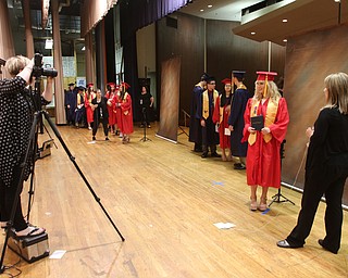             ROBERT  K. YOSAY | THE VINDICATOR..Austintown Fitch High School graduated over 300 students in the Fitch Gym Saturday morning as the graduation season is coming to a close..Getting the memory as school photographers take each students photograph