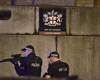 An armed Police officer looks through his weapon on London Bridge in London, Saturday, June 3, 2017.  British police said they were dealing with "incidents" on London Bridge and nearby Borough Market in the heart of the British capital Saturday, as witnesses reported a vehicle veering off the road and hitting several pedestrians. (Dominic Lipinski/PA via AP)
