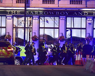Police Officers walking on Borough High Street as police are dealing with an incident on London Bridge in London, Saturday, June 3, 2017.    Witnesses reported a vehicle hitting pedestrians and injured people on the ground. (Dominic Lipinski/PA via AP)