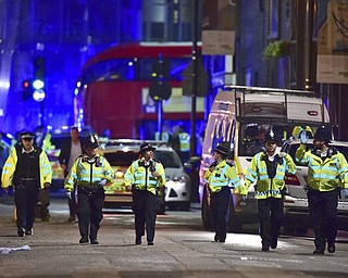 Police officers on Borough High Street as police are dealing with an incident on London Bridge in London, Saturday, June 3, 2017.    Witnesses reported a vehicle hitting pedestrians and injured people on the ground. (Dominic Lipinski/PA via AP)