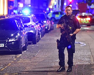 An armed police stands on Borough High Street as police are dealing with an incident on London Bridge in London, Saturday, June 3, 2017.    Witnesses reported a vehicle hitting pedestrians and injured people on the ground. (Dominic Lipinski/PA via AP)