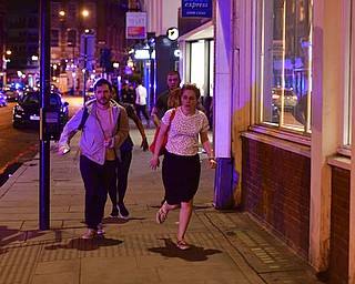 People run down Borough High Street as police are dealing with a "major incident" at London Bridge in London, Saturday, June 3, 2017.  London incident. (Dominic Lipinski/PA via AP)