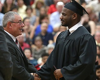 Ronald Williams shakes xxx hand after receiving his diploma during the Canfield High School commencement, Sunday, June 4, 2017 in Canfield...(Nikos Frazier | The Vindicator)