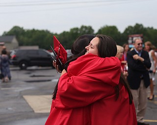 Sydney Stewart hugs Kaelin Kabetso after the Canfield High School commencement, Sunday, June 4, 2017 in Canfield...(Nikos Frazier | The Vindicator)