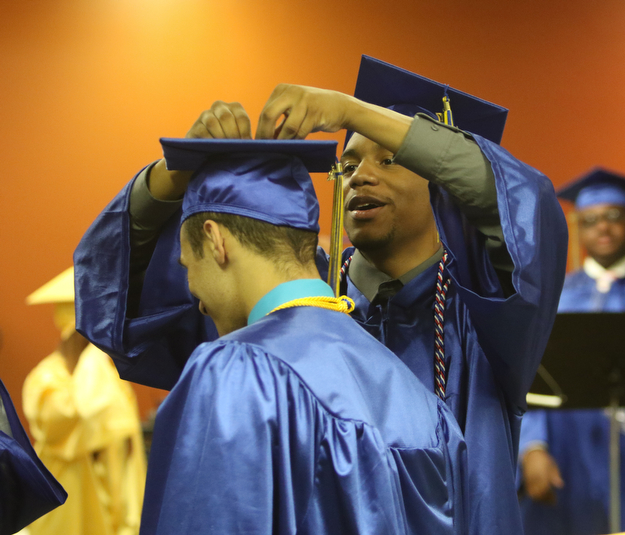             ROBERT  K. YOSAY | THE VINDICATOR..Valley Christian graduated over 50 students  at Highway Tabernacle Church in Austintown Sunday afternoon...a helping hand...  with a tassel