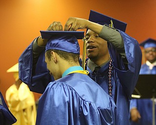             ROBERT  K. YOSAY | THE VINDICATOR..Valley Christian graduated over 50 students  at Highway Tabernacle Church in Austintown Sunday afternoon...a helping hand...  with a tassel