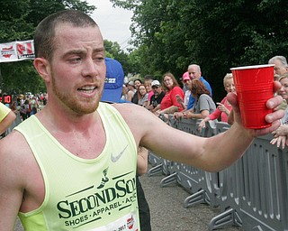 William D Lewis The Vindicator Youngstown Marathon winner Tony Migliozzi of North Canton celebrated his victory with a beer a the finish line.