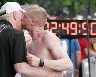 William D Lewis The Vindicator  Youngstown Marathon 2nd place runner Erik Reed of East Liverpool gets a kiss from his dad John day at finish line.