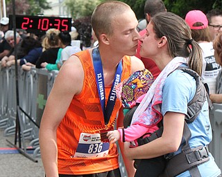 William D Lewis The Vindicator  Half marathon runner Stephen Zubyk of Hubbard kisses wife and daughter Poppy(9 months) at finish of Youngstown Marathon 6-4-17in Boardman.