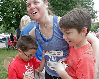 William D Lewis The Vindicator  Half marathon runner Andrea Smesko of Canfield embraces her sons JD, 9, left, and Dylan, 10, at finish of Youngstown Marathon.