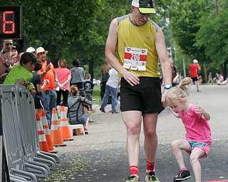 William D Lewis The Vindicator  Youngstown Marathon runner Travis Simpson of Wierton W.Va and his daughter HArper, 4, at finish line.