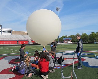 Neighbors | Alexis Bartolomucci.Eighth-grade STEM students prepared the weather ballon for the launch on May 10 at Austintown Middle School.