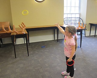 Neighbors | Alexis Bartolomucci.Rylynn threw a ring around antlers for a ring toss game at the "Be Our Guest" event on May 20 at the Poland library.