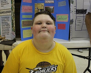 Neighbors | Abby Slanker.A Hilltop Elementary School fourth-grade student experimented on which liquid would freeze the fastest for the school’s annual Science Fair on May 26.