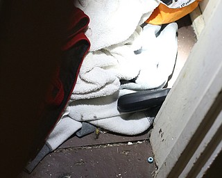 A police officer shines a flashlight on a revolver found in a hallway closet as Youngstown Police search a house on the 200 block of E Judson Ave, Thursday, June 1, 2017 in Youngstown...(Nikos Frazier | The Vindicator)