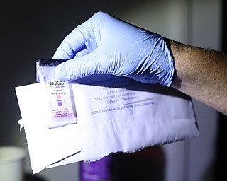 A police officer field tests a suspected bag of Fentanyl as Youngstown Police search a house on the 200 block of E Judson Ave, Thursday, June 1, 2017 in Youngstown. The sample tested positive. ..(Nikos Frazier | The Vindicator)
