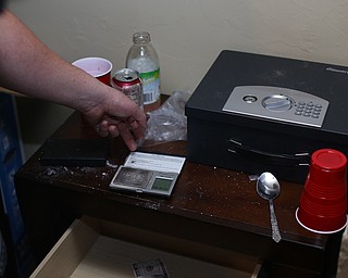 A police officer closes the top to a digital scale with traces of drugs as Youngstown Police search a house on the 200 block of E Judson Ave, Thursday, June 1, 2017 in Youngstown...(Nikos Frazier | The Vindicator)