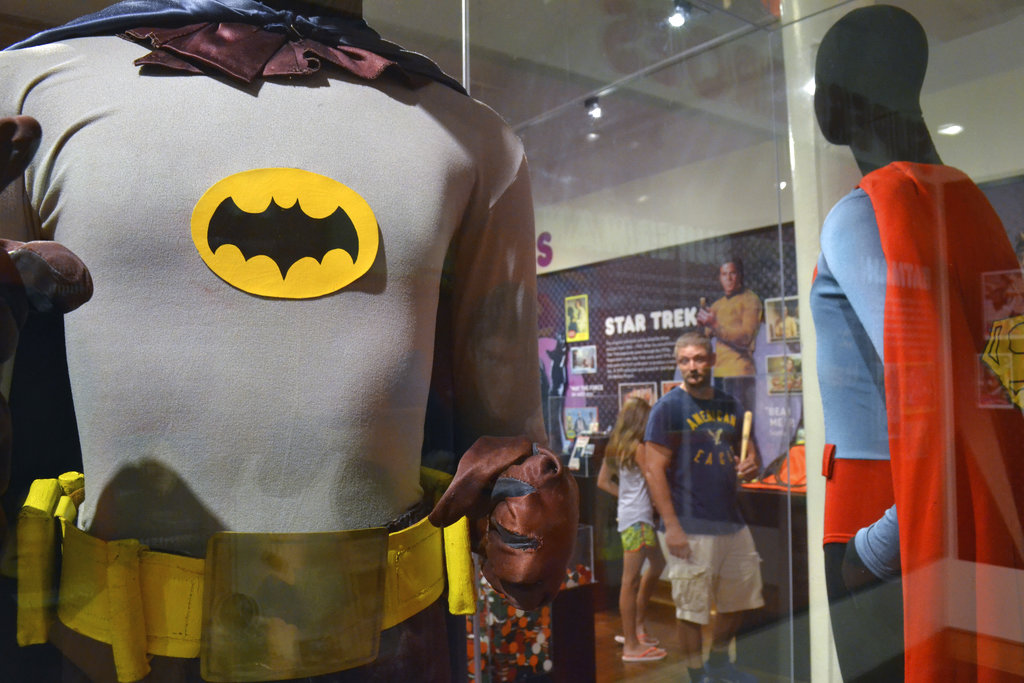 FILE - In this May 29, 2015 file photo, a Batman costume worn by Adam West in the 1960s television show is on display next a Superman costume worn by Christopher Reeve in "Superman IV" at the Louisville Slugger Museum in Louisville, Ky. On Saturday, June 10, 2017, Westâ€™s family said the actor has died at age 88. (AP Photo/Dylan Lovan)