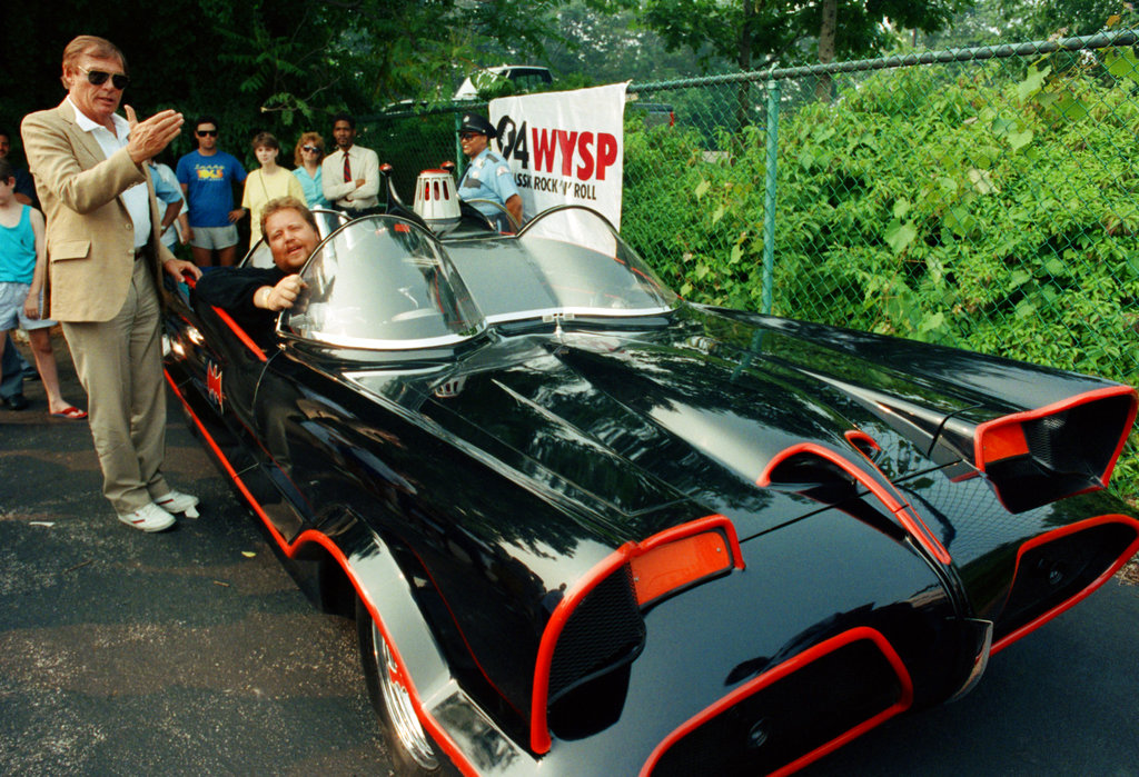 FILE - In this June 27, 1989 file photo, Adam West, left, stands beside the old Batmobile driven by owner Scott Chinery in Philadelphia. On Saturday, June 10, 2017, his family said the actor, who portrayed Batman in a 1960s TV series, has died at age 88. (AP Photo/Cristy Rickard, File)