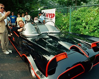 FILE - In this June 27, 1989 file photo, Adam West, left, stands beside the old Batmobile driven by owner Scott Chinery in Philadelphia. On Saturday, June 10, 2017, his family said the actor, who portrayed Batman in a 1960s TV series, has died at age 88. (AP Photo/Cristy Rickard, File)