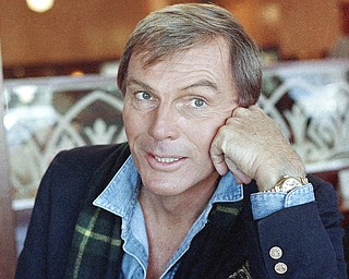 FILE - In this Dec. 11, 1985 file photo, Adam West poses for a photo in Los Angeles. On Saturday, June 10, 2017, his family said the actor, who portrayed Batman in a 1960s TV series, has died at age 88. (AP Photo/Lennox McLendon, File)