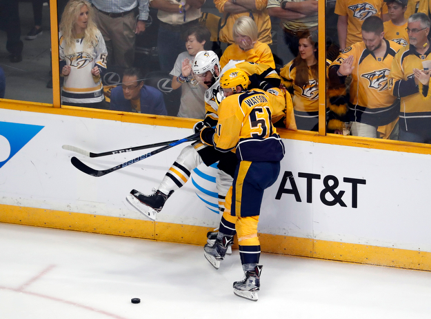 Nashville Predators's Austin Watson (51) battles for the puck against Pittsburgh Penguins' Justin Schultz (4) during the first period of Game 6 of the NHL hockey Stanley Cup Final, Sunday, June 11, 2017, in Nashville, Tenn. (AP Photo/Jeff Roberson)