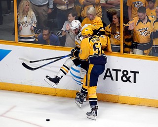 Nashville Predators's Austin Watson (51) battles for the puck against Pittsburgh Penguins' Justin Schultz (4) during the first period of Game 6 of the NHL hockey Stanley Cup Final, Sunday, June 11, 2017, in Nashville, Tenn. (AP Photo/Jeff Roberson)