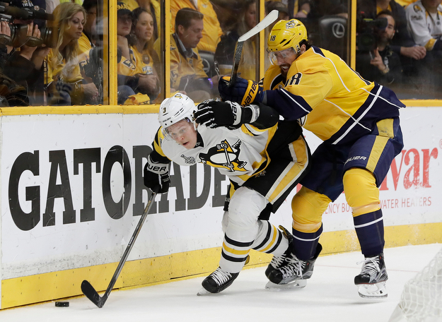 Pittsburgh Penguins' Olli Maatta (3), of Finland, and Nashville Predators' James Neal (18) battle for the puck during the first period of Game 6 of the NHL hockey Stanley Cup Final, Sunday, June 11, 2017, in Nashville, Tenn. (AP Photo/Mark Humphrey)