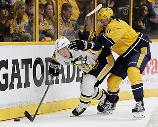 Pittsburgh Penguins' Olli Maatta (3), of Finland, and Nashville Predators' James Neal (18) battle for the puck during the first period of Game 6 of the NHL hockey Stanley Cup Final, Sunday, June 11, 2017, in Nashville, Tenn. (AP Photo/Mark Humphrey)