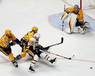 Pittsburgh Penguins' Bryan Rust (17) battles for the puck against Nashville Predators's Cody McLeod (55) and Matt Irwin (52) as Nashville Predators goalie Pekka Rinne (35), of Finland, guards the goal during the second period of Game 6 of the NHL hockey Stanley Cup Final, Sunday, June 11, 2017, in Nashville, Tenn. (AP Photo/Jeff Roberson)