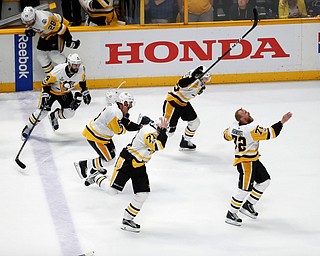 Pittsburgh Penguins players celebrate after defeating Nashville Predators 2-0 in Game 6 of the NHL hockey Stanley Cup Final, Sunday, June 11, 2017, in Nashville, Tenn. (AP Photo/Jeff Roberson)