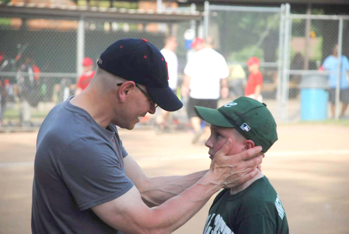 Keith Carpenter, seen with youngest son Evan, is in the U.S. army Reserve and spends his free time coaching. 