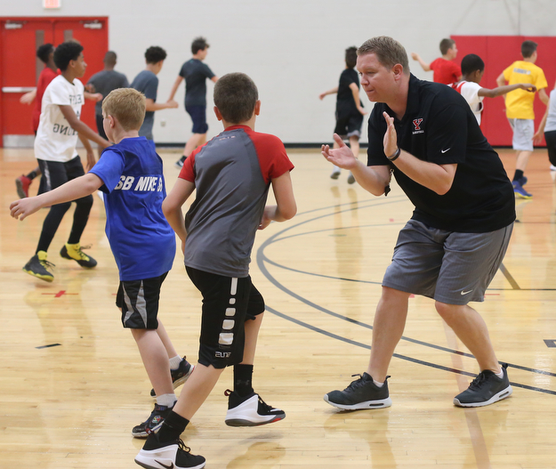 Jerrod Calhoun, YSU mens basketball coach, encourages the kids during warmups during a basketball camp at the Stambaugh Stadium Basketball courts, Wednesday, June 14, 2017 in Youngstown...(Nikos Frazier | The Vindicator)