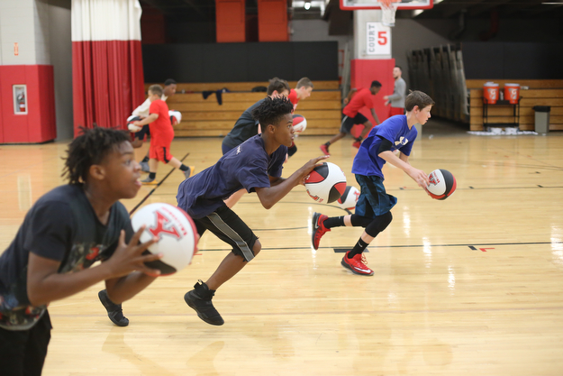 Markwuan Brown(14)(center) of Warren runs a drill during a basketball camp at the Stambaugh Stadium Basketball courts, Wednesday, June 14, 2017 in Youngstown...(Nikos Frazier | The Vindicator)