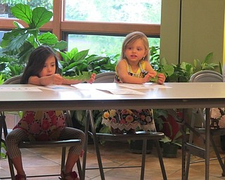 Neighbors | Alexis Bartolomucci.Girls at the dandelion Sprout Club program on May 18 at Fellows Riverside Gardens looked at the leaves of the dandelions.