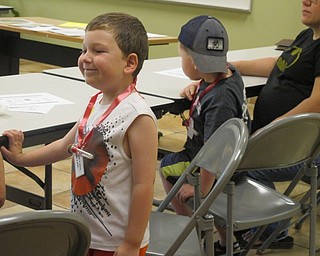 Neighbors | Alexis Bartolomucci.One of the children showed off his wish necklace he made with dandelion seeds during Fellow Riverside Gardens Sprout Club program on dandelions.