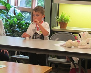 Neighbors | Alexis Bartolomucci.One of the children used a stem of a dandelion to try and blow bubbles during the dandelion Sprout Club program.
