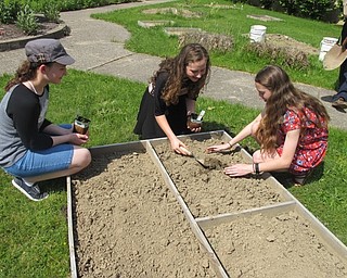 Neighbors | Alexis Bartolomucci.Helping Our Plant Earth (H.O.P.E.) club students at Glenwood Junior High helped plant flowers in their courtyard garden on May 18.