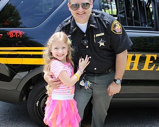 Neighbors | Abby Slanker.Mahoning County Deputy Sheriff Sam Oliver got a hug from his daughter while he visited Hilltop Elementary School’s Vehicle Career Day on May 19.