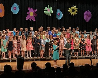 Neighbors | Alexis Bartolomucci.Second-grade Poland Union students came to the front of the stage between songs to introduce the next song during the concert.
