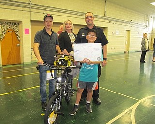 Neighbors | Alexis Bartolomucci.Ben Wang was the first place winner at Robinwood Lane Elementary of the bike safety poster and won a bike and helmet. Pictured are, from left, (front) Eddy Wang and Ben Wang; (back) Nancy Hildebrand and Sgt. Chuck Hillman.